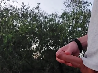 Young male stud cruising and jerking off at the bring to light lakeshore then busts a public nut